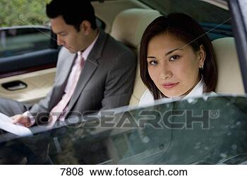 Stock Photo - businessman and 
woman sitting 
in backseat of 
car,  focus on 
woman. fotosearch 
- search stock 
photos, pictures, 
images, and photo 
clipart