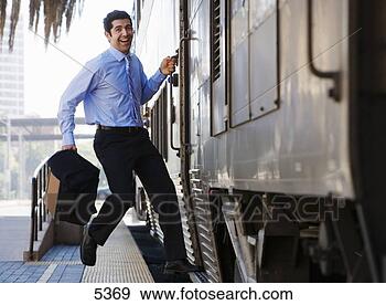 Stock Photograph - late businessman 
hurrying to catch 
passenger train, 
 leaping onto. 
fotosearch - search 
stock photos, 
pictures, images, 
and photo clipart