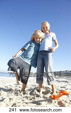Stock Photography - boy (6-8) and 
girl (7-9) standing 
on beach,  boy 
leaning on girl. 
fotosearch - search 
stock photos, 
pictures, images, 
and photo clipart