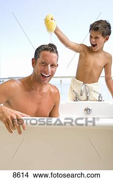 Stock Photo - father and son 
in bathroom,  
son (6-8) holding 
sponge above father's. 
fotosearch - search 
stock photos, 
pictures, images, 
and photo clipart