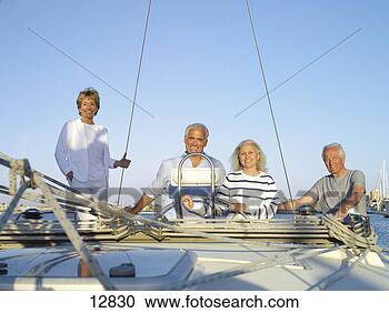 Stock Photography - mature couple 
at wheel of boat 
flanked by senior 
couple,  smiling. 
fotosearch - search 
stock photos, 
pictures, images, 
and photo clipart