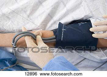 Stock Photo - medic taking patients 
blood pressure, 
close-up of hands. 
fotosearch - search 
stock photos, 
pictures, images, 
and photo clipart