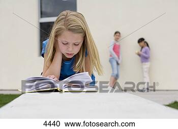 Stock Photography - girl (9-11) reading 
book outside school, 
 two girls talking 
beside. fotosearch 
- search stock 
photos, pictures, 
images, and photo 
clipart