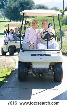 Stock Photo - two mature couples 
driving golf buggies 
along golf course 
pathway. fotosearch 
- search stock 
photos, pictures, 
images, and photo 
clipart