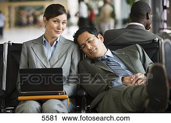Stock Photography - two business people 
sitting in airport 
terminal,  tired 
man resting. fotosearch 
- search stock 
photos, pictures, 
images, and photo 
clipart