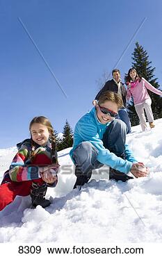Stock Photograph - boy and girl (7-9) 
making snow balls 
in snow field, 
 smiling. fotosearch 
- search stock 
photos, pictures, 
images, and photo 
clipart