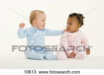 Stock Photo - baby boy and girl 
(3-6 months) looking 
at each other, 
 boy with hand. 
fotosearch - search 
stock photos, 
pictures, images, 
and photo clipart