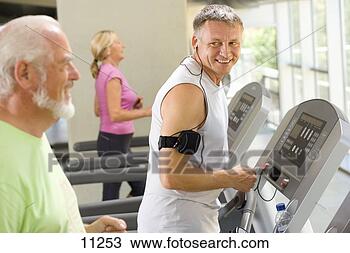 Stock Photo - mature man on 
treadmill smiling 
at senior man 
on treadmill. 
fotosearch - search 
stock photos, 
pictures, images, 
and photo clipart