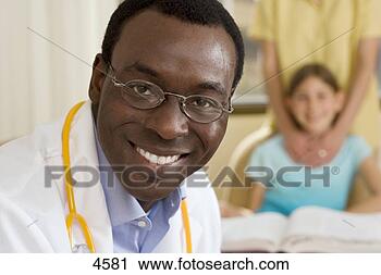 Stock Photography - patient lying 
in hospital bed, 
 focus on doctor 
in foreground. 
fotosearch - search 
stock photos, 
pictures, images, 
and photo clipart