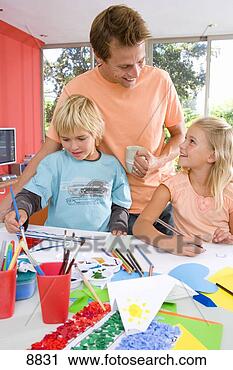 Stock Photography - father standing 
by son and daughter(6-8) 
sitting at art 
and crafts. fotosearch 
- search stock 
photos, pictures, 
images, and photo 
clipart