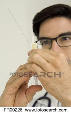 Stock Photo - doctor with hypodermic 
syringe, focus 
on hands. fotosearch 
- search stock 
photos, pictures, 
images, and photo 
clipart