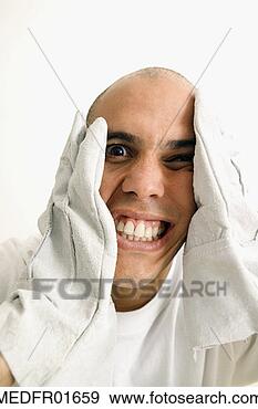 Stock Photograph - nearly bald man 
making a face 
and holding gloves 
to sides of head. 
fotosearch - search 
stock photos, 
pictures, images, 
and photo clipart