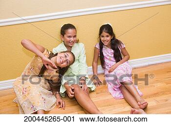 Stock Photography - girls (10-12) 
sitting on floor, 
smiling. fotosearch 
- search stock 
photos, pictures, 
images, and photo 
clipart