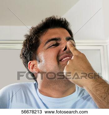 Stock Photo - close-up of a 
mid adult man 
pressing his nose. 
fotosearch - search 
stock photos, 
pictures, images, 
and photo clipart