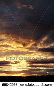 Stock Photo - dramatic black 
and golden sunset 
under a cloudy 
sky. fotosearch 
- search stock 
photos, pictures, 
images, and photo 
clipart