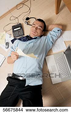 Stock Photo - high angle view 
of a businessman 
lying on the floor. 
fotosearch - search 
stock photos, 
pictures, images, 
and photo clipart
