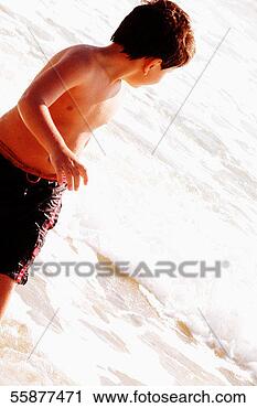 Stock Photography - latin boy standing 
in water. fotosearch 
- search stock 
photos, pictures, 
images, and photo 
clipart