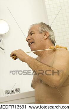 Stock Photography - senior bare chested 
senior man using 
back massager. 
fotosearch - search 
stock photos, 
pictures, images, 
and photo clipart