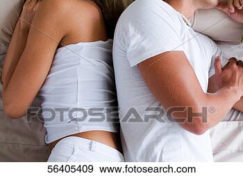 Stock Photograph - side profile of 
a couple lying 
on a bed. fotosearch 
- search stock 
photos, pictures, 
images, and photo 
clipart