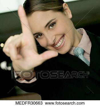 Stock Photo - smiling young 
businesswoman 
gesturing with 
thumb and forefinger. 
fotosearch - search 
stock photos, 
pictures, images, 
and photo clipart