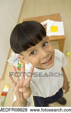 Stock Photo - young boy standing 
and holding up 
four fingers, 
close-up. fotosearch 
- search stock 
photos, pictures, 
images, and photo 
clipart