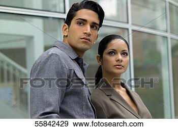 Stock Photograph - young couple standing 
outdoors in front 
of windows with 
reflection. fotosearch 
- search stock 
photos, pictures, 
images, and photo 
clipart
