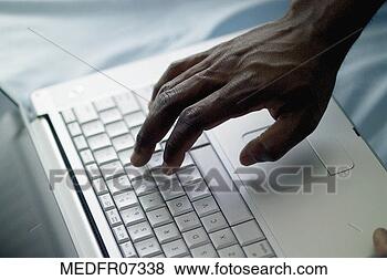 Stock Photo - hand on laptop 
computer keyboard, 
close-up. fotosearch 
- search stock 
photos, pictures, 
images, and photo 
clipart