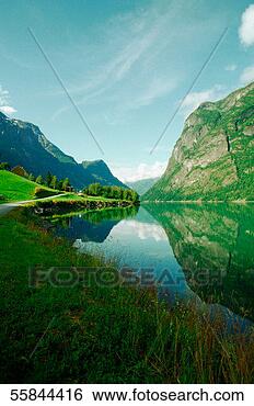 Stock Photo - reflection of 
mountains in water, 
nordfjord, olden, 
norway. fotosearch 
- search stock 
photos, pictures, 
images, and photo 
clipart