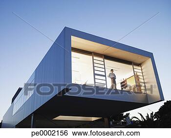 Stock Photo - exterior of a 
modern office 
building with 
man looking out 
window. fotosearch 
- search stock 
photos, pictures, 
images, and photo 
clipart