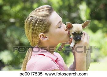 Stock Image - girl kissing puppy 
dog. fotosearch 
- search stock 
photos, pictures, 
images, and photo 
clipart