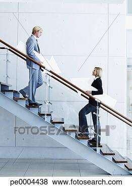 Stock Photo - male and female 
office workers 
on staircase holding 
arrow signs. fotosearch 
- search stock 
photos, pictures, 
images, and photo 
clipart