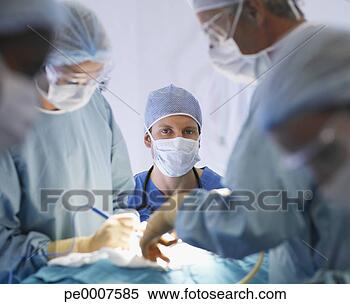Stock Image - team of nurses 
and surgeons in 
surgery. fotosearch 
- search stock 
photos, pictures, 
images, and photo 
clipart