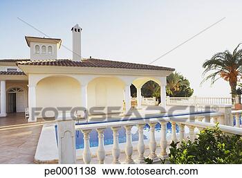 Stock Photo - building and outdoor 
pool with palm 
trees. fotosearch 
- search stock 
photos, pictures, 
images, and photo 
clipart