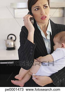 Stock Photo - businesswoman 
talking on phone 
holding sleeping 
baby. fotosearch 
- search stock 
photos, pictures, 
images, and photo 
clipart