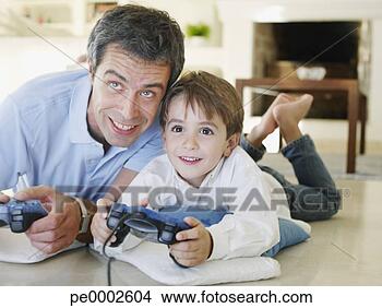 Stock Photo - father and son 
playing video 
game together. 
fotosearch - search 
stock photos, 
pictures, images, 
and photo clipart
