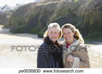 Stock Photography - one mature and 
one senior woman 
on the beach. 
fotosearch - search 
stock photos, 
pictures, images, 
and photo clipart