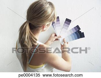 Stock Image - rear view of woman 
with paint samples. 
fotosearch - search 
stock photos, 
pictures, images, 
and photo clipart