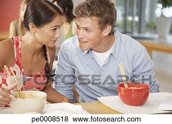 Stock Photo - teenage boy and 
girl sharing noodle 
in cafeteria. 
fotosearch - search 
stock photos, 
pictures, images, 
and photo clipart