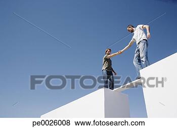 Stock Photo - two men atop two 
walls balancing 
on a plank. fotosearch 
- search stock 
photos, pictures, 
images, and photo 
clipart