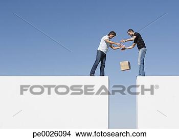 Stock Photo - two men atop two 
walls dropping 
a box. fotosearch 
- search stock 
photos, pictures, 
images, and photo 
clipart
