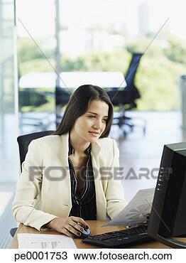 Stock Photo - woman in office 
working on her 
personal computer. 
fotosearch - search 
stock photos, 
pictures, images, 
and photo clipart