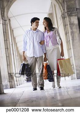 Stock Photo - young couple with 
shopping bags 
walking in an 
old european colonnade. 
fotosearch - search 
stock photos, 
pictures, images, 
and photo clipart