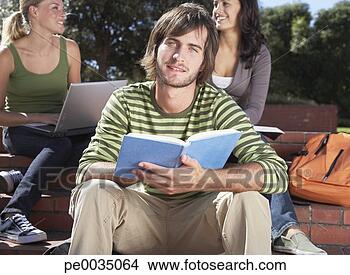 A young man with an open book with two young women in the background
View Large Photo Image Stock Photo - a young man with
an open book with
two young women
in the background.
fotosearch - search
stock photos,
pictures, wall
murals, images,
and photo clipart