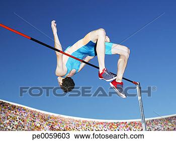 Stock Photo - athlete high jumping 
in an arena. fotosearch 
- search stock 
photos, pictures, 
images, and photo 
clipart