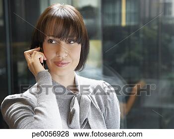 Stock Photo - businesswoman 
on her mobile 
phone in an office. 
fotosearch - search 
stock photos, 
pictures, images, 
and photo clipart