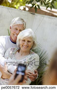 Stock Photo - couple having 
picture taking 
with camera phone 
outdoors. fotosearch 
- search stock 
photos, pictures, 
images, and photo 
clipart