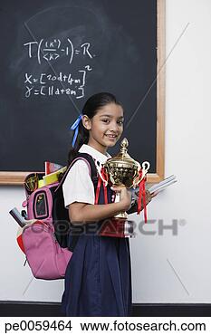 Stock Photo - girl with trophy 
by blackboard 
in classroom. 
fotosearch - search 
stock photos, 
pictures, images, 
and photo clipart