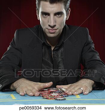 Stock Photo - man with betting 
chips on casino 
table. fotosearch 
- search stock 
photos, pictures, 
images, and photo 
clipart