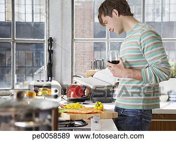Stock Photograph - man with book 
and wine in kitchen. 
fotosearch - search 
stock photos, 
pictures, images, 
and photo clipart