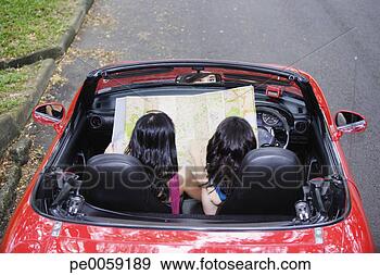 Stock Photograph - rear view of two 
women in a convertible 
car looking at 
map. fotosearch 
- search stock 
photos, pictures, 
images, and photo 
clipart